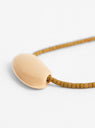 Flat Oval Gold Plated Pendant and Miyuki Chain Olive from Helene Rohner at Couverture & The Garbstore
Close-up